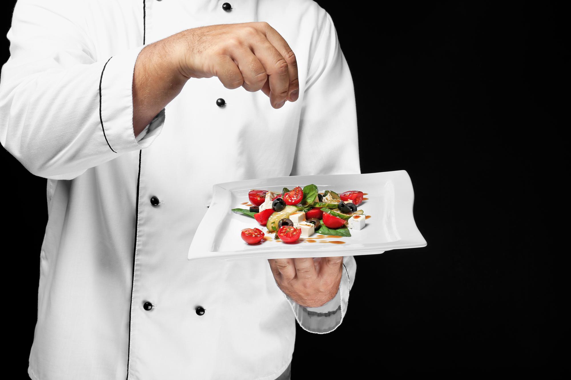Chef presenting plated gourmet dish